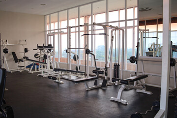 Fototapeta na wymiar Modern of gym interior with equipment. Sports equipment in the gym.