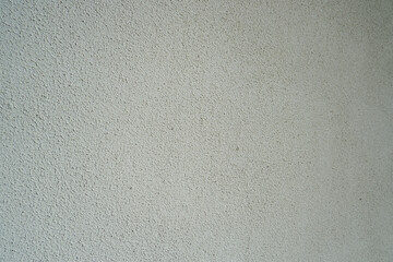 Gray structural painted wallpaper on the wall. Grunge texture background. Grungy painted wall with decorative parget gray stucco texture background. Structural plaster