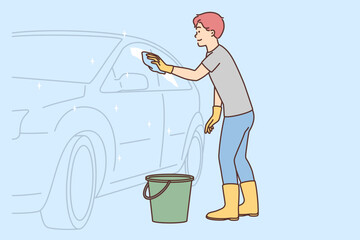 Smiling man cleaning car with detergent 