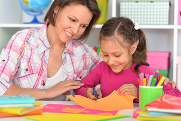 Mother teaches her cute daughter to do craft items