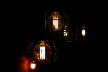 Fototapeta na wymiar Indoor LED lighting lamps in dark room creating glowing light. Light bulb with low energy filament. Energy efficiency concept