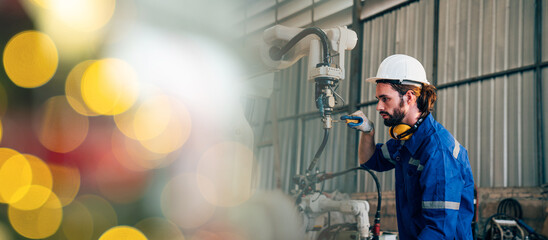 Industrial engineer wearing a white helmet working in industrial factory. 