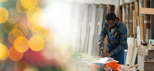 Afro american craftsman working as carpenter in a carpentry workshop, Small family business concept of entrepreneurs.