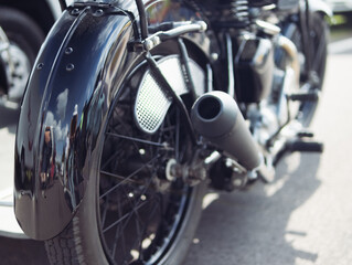 Fototapeta premium motorcycle rear wheel close-up, isolated motorcycle wheel on the street at the exhibition background blurred