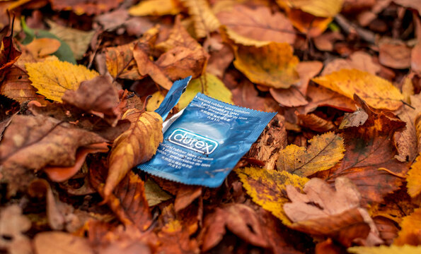 Sibiu city, Romania - November 14, 2020. condom packaging in the forest among the leaves