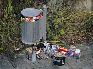 New Years garbage. Fireworks batterys next to a trash can on the footpath after the traditional new...