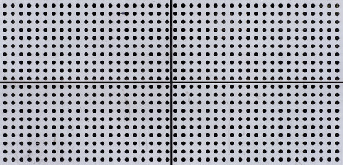 Old Rough Scratched Perforated Metal Steel Panel Surface Blocks with Small Round Holes Pattern.
