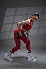 Fototapeta na wymiar Athletic fitness woman working out, studio shot