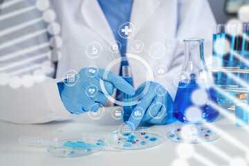 Fototapeta premium Female chemist scientist holding test tube and tablet conducting experiment in laboratory with equipment, science concept.