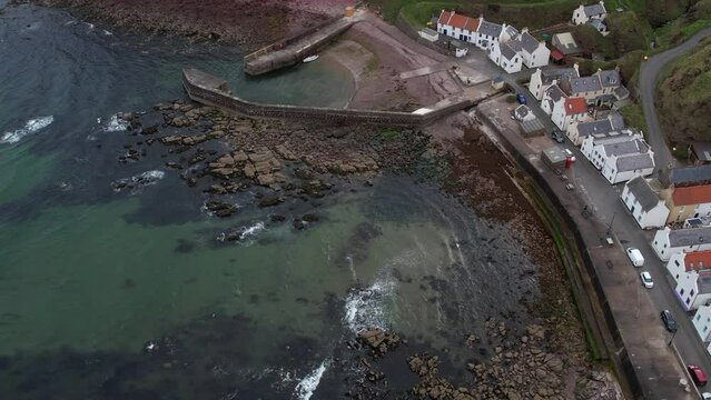aerial shot over the village of Pennan, a small seaside town in Aberdeenshire. Scotland, UK. You can see the coast and the houses of this small town.