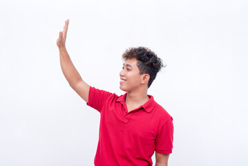 A young man saying hi to someone at the left. Isolated on a white background.