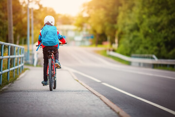 Teenager in the morning hurrying on bicycle to the lesson