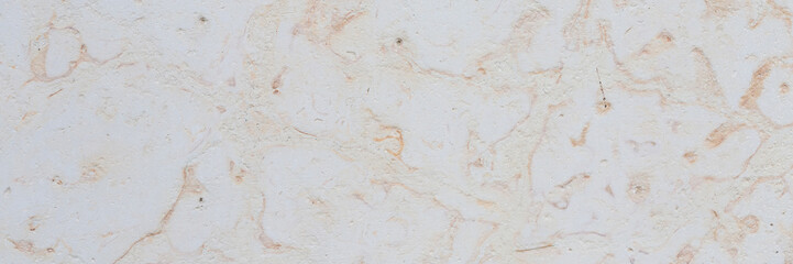 Dolomite texture. Natural rock with beautiful beige patterns on the surface. Polished flat stone. Classic luxury decoration building material. Wide panoramic texture for background and design.