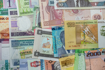 Fototapeta na wymiar Various African banknotes stacked on top of each other forming a money background.