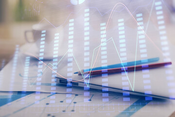 Forex graph hologram on table with computer background. Double exposure. Concept of financial markets.