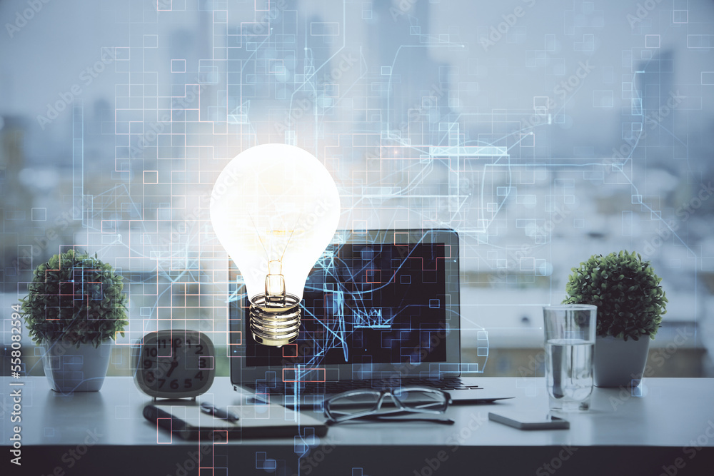 Poster Computer on desktop in office with bulb icon hologram. Double exposure. Concept of idea.