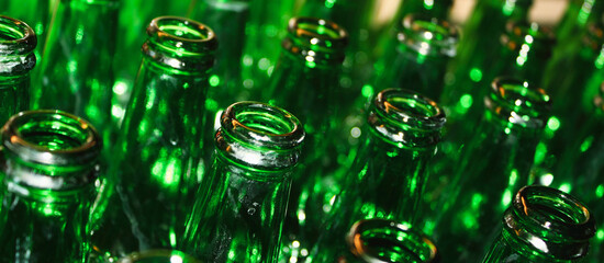 Green glass empty beer bottle open top closeup
