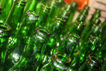 Green glass empty beer bottle open top closeup