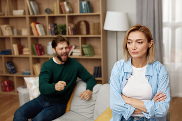 Couple Having Argument At Home. Angry Spouses Don't Speak With Each Other. Frustrated Husband And Annoyed Wife Quarrelling About Bad Marriage Relationships