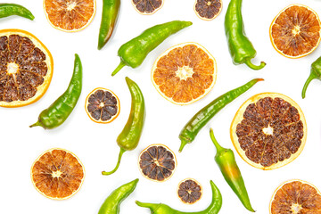 hot green peppers and dried citrus fruit on a white background. grocery organic flatley