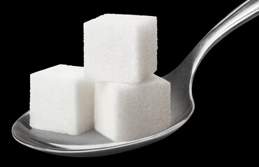 Sugar cubes in metal spoon, isolated on black background
