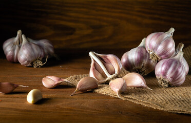 Garlic cloves on a vintage rustic table. Fresh peeled garlic and onions.