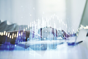 Multi exposure of abstract financial diagram with hand typing on computer keyboard on background, banking and accounting concept