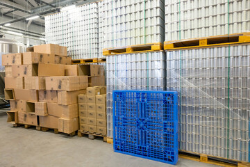 Warehouse interior with drink aluminum cans and cartons
