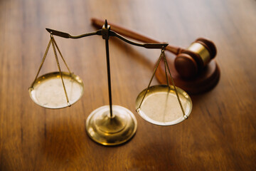 Business and lawyers discussing contract papers with brass scale on desk in office. Law, legal...