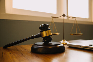 Business and lawyers discussing contract papers with brass scale on desk in office. Law, legal services, advice, justice and law concept picture with film grain effect