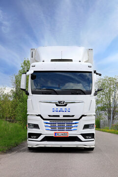 New, White MAN TGX Truck in Front of Refrigerated Trailer, Vertical view. 