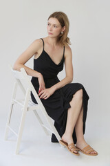 Serie of studio photos of young female model in comfortable yet stylish cotton black dress