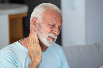 Senior elderly man touching his neck, suffering from neck pain, sciatica, sedentary lifestyle...