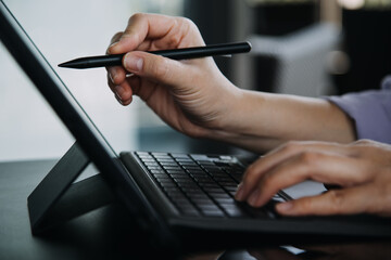 Asian colleagues man and woman discussing and working with laptop computer on office desk in the office