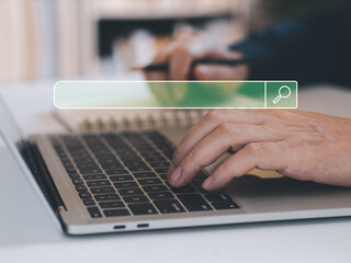 Online internet search concept. Person hand search online via laptops on table, internet technology...