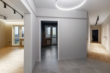 Chrome handle with keyhole on white door with panels in frames. Entrance. Close-up photo of architecture detail