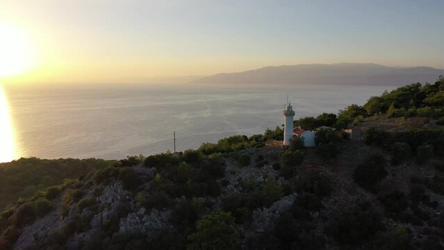 Aerial View of Lighthouse on Cape Above Mediterranean Sea at Sunset, Drone Shot