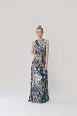 Serie of studio photos of young female model in colorful tropical print sleeveless wrap dress