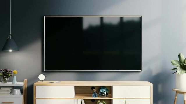 Modern interior of living room with tv on the cabinet on dark blue wall background.