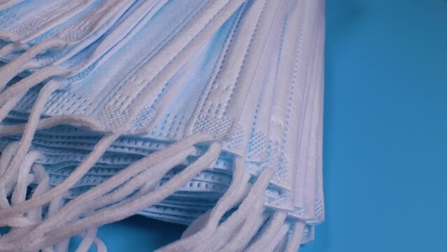 stack of medical protective face masks rotates. The concept of protection from viruses, infections