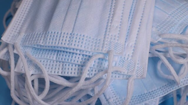 stack of medical protective face masks rotates. The concept of protection from viruses, infections
