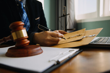 Business and lawyers discussing contract papers with brass scale on desk in office. Law, legal services, advice, justice and law concept picture with film grain effect