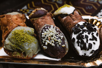 Cannoli. The typical Italian sweet. Filled with Pistachio, Chocolate and Ricotta.   