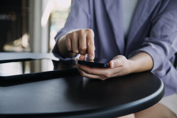Asian colleagues man and woman discussing and working with laptop computer on office desk in the office