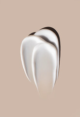 cosmetic smears of creamy texture on a beige background