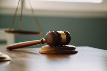 Business and lawyers discussing contract papers with brass scale on desk in office. Law, legal services, advice, justice and law concept picture with film grain effect