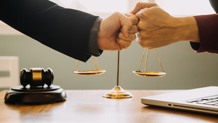 Business and lawyers discussing contract papers with brass scale on desk in office. Law, legal...