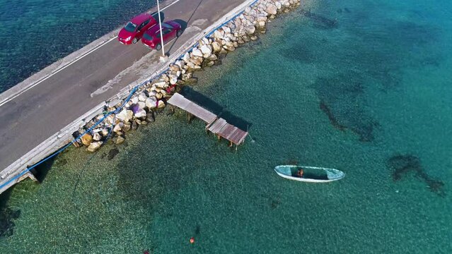 Drone view of cars on the road passing through the middle of the sea in izmir urla