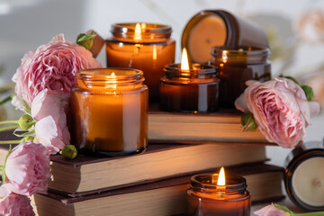 A set of different aroma candles in brown glass jars. Scented handmade candle. Soy candles are...