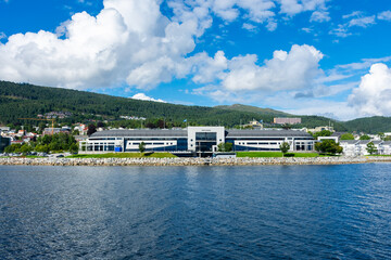  Modern Aker Stadium on the background of Scandinavian mountains and blue sky. Sunny day in Molde,...
